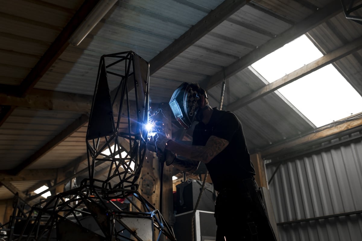 artisan sculpteur faisant une soudure sur une oeuvre