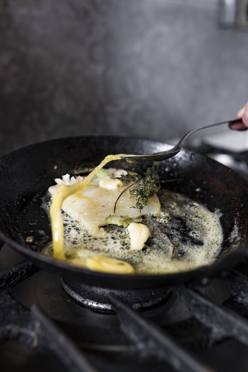 Gros plan sur la cuisson d'un poisson à la poêle